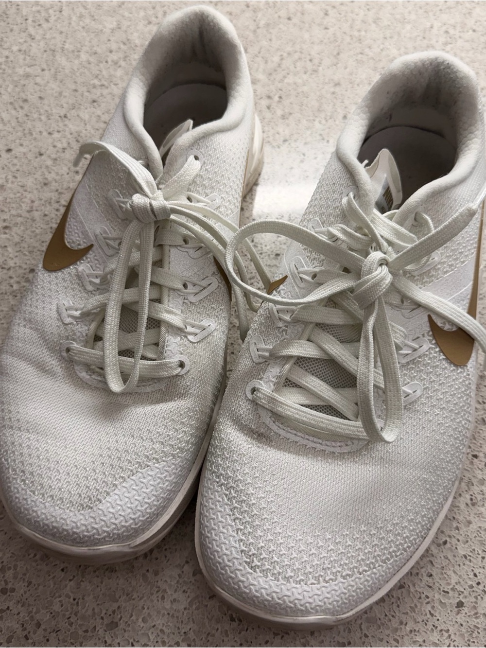 Nike Women’s Athletic Shoes in White with Gold Swoosh